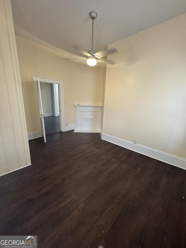 spare room featuring ceiling fan and dark hardwood / wood-style flooring