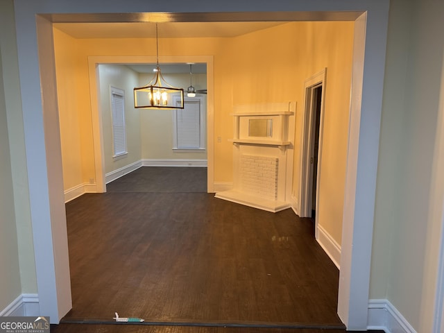 unfurnished dining area featuring dark hardwood / wood-style floors and a notable chandelier