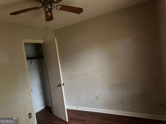 unfurnished bedroom featuring ceiling fan, a closet, and dark hardwood / wood-style floors