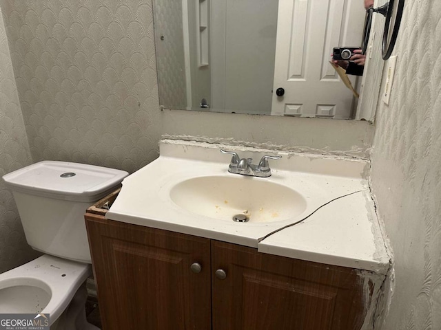 bathroom featuring vanity and toilet