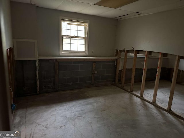 basement with a paneled ceiling