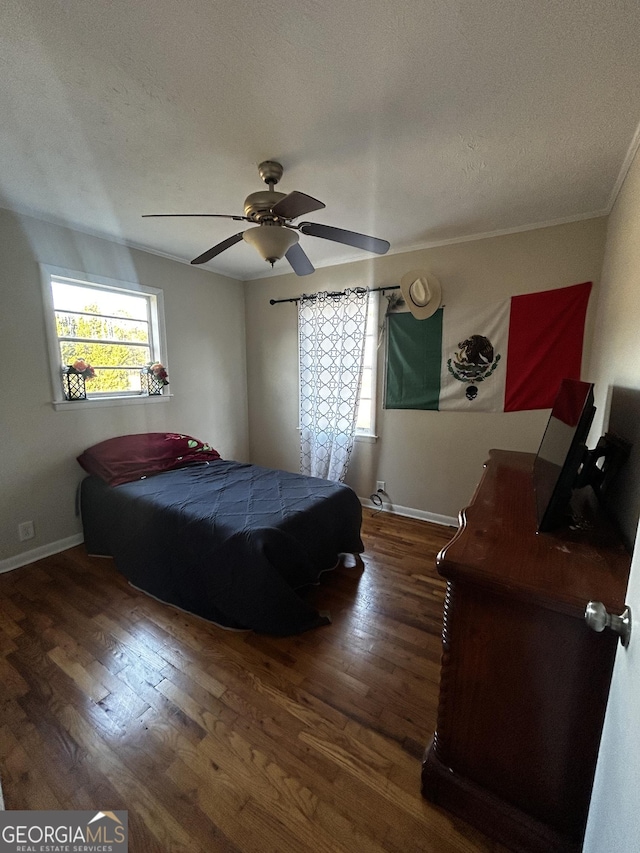 bedroom featuring a textured ceiling, dark hardwood / wood-style floors, and ceiling fan