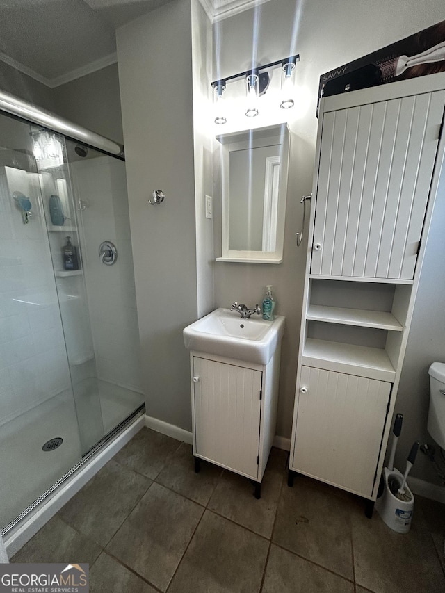 bathroom featuring toilet, vanity, tile patterned flooring, and walk in shower