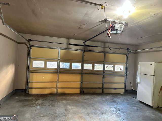 garage with white refrigerator and a garage door opener