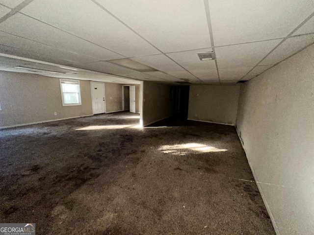 carpeted empty room featuring a paneled ceiling