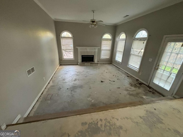 unfurnished living room featuring a tile fireplace, ceiling fan, and ornamental molding