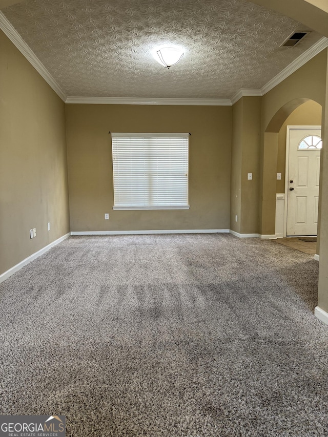 carpeted empty room featuring a textured ceiling and ornamental molding