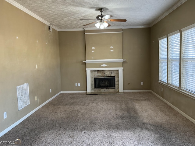 unfurnished living room featuring carpet flooring, a tile fireplace, ceiling fan, and ornamental molding