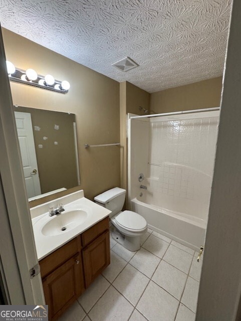 full bathroom with vanity, a textured ceiling, bathing tub / shower combination, tile patterned flooring, and toilet