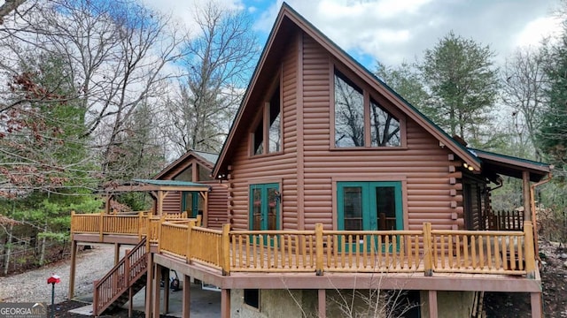 rear view of property with french doors and a deck