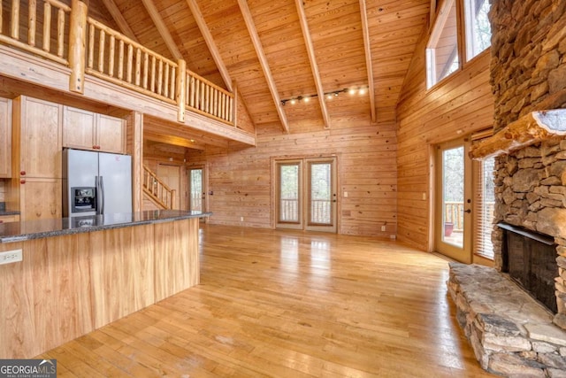 236 William Branch Rd, Morganton, GA 30560 - unfurnished living room featuring beam ceiling, high vaulted ceiling, a stone fireplace, wooden ceiling, and stairway