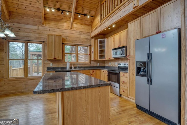 kitchen featuring a center island, light brown cabinetry, light hardwood / wood-style floors, wood ceiling, and stainless steel appliances