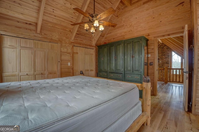 236 William Branch Rd, Morganton, GA 30560 - bedroom with light wood finished floors, beam ceiling, and wooden walls
