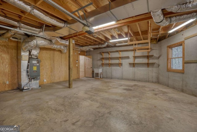 basement featuring sink and heating unit