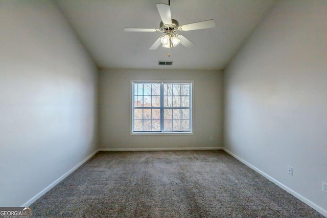 carpeted spare room featuring ceiling fan and vaulted ceiling