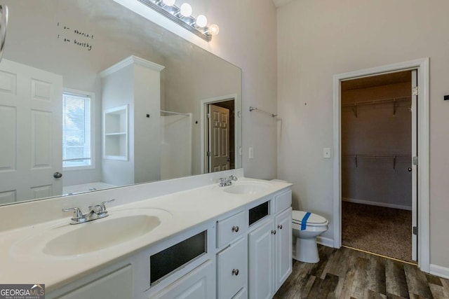 full bathroom with hardwood / wood-style flooring, vanity, separate shower and tub, and toilet