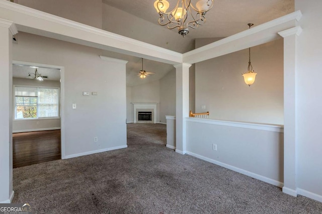 interior space with ceiling fan with notable chandelier, carpet, and vaulted ceiling