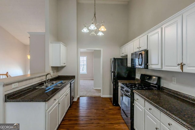 kitchen with sink, black appliances, an inviting chandelier, white cabinetry, and hanging light fixtures