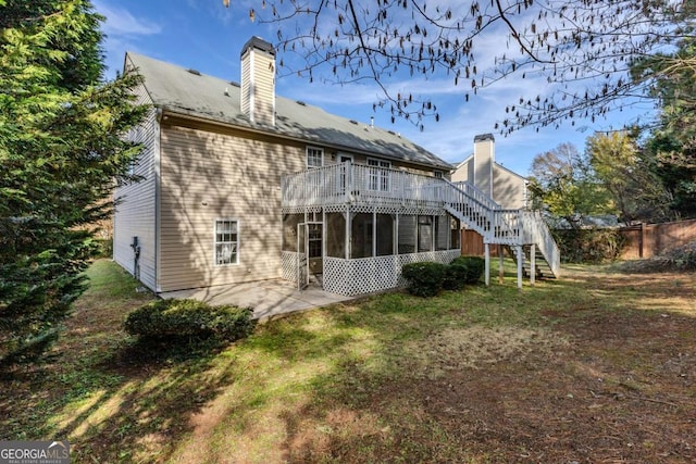 back of house featuring a patio area and a sunroom