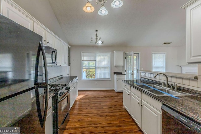 kitchen featuring lofted ceiling, dark wood-type flooring, black appliances, white cabinets, and sink