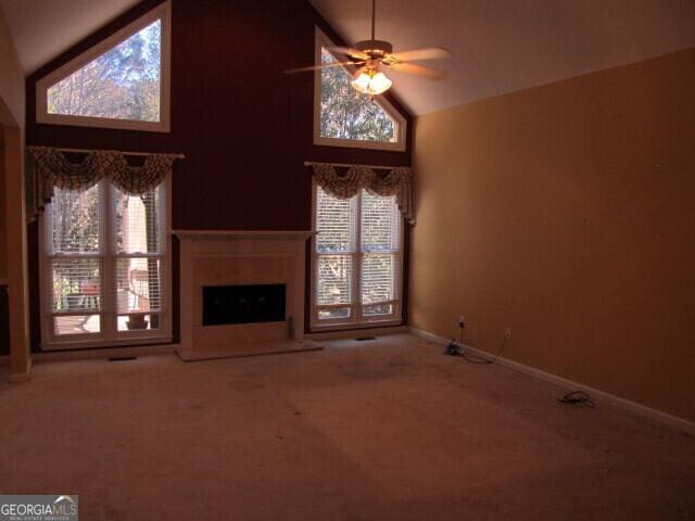 unfurnished living room with carpet floors and a healthy amount of sunlight