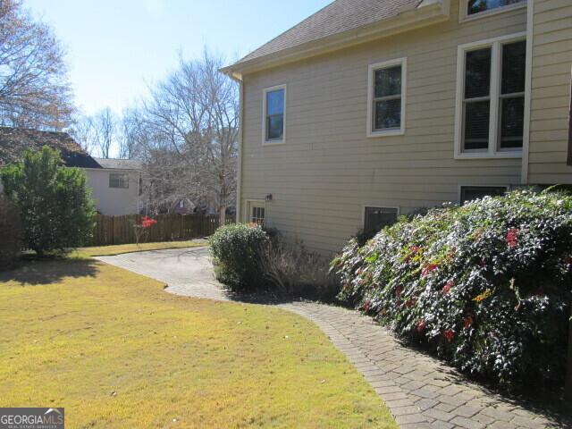 view of property exterior featuring a lawn