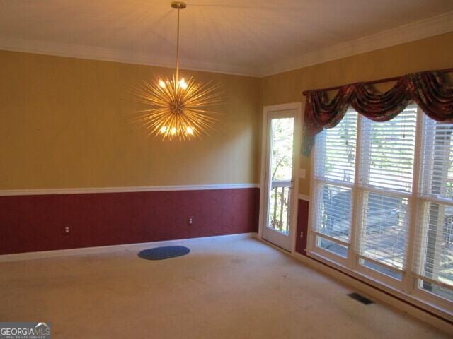 unfurnished dining area with carpet, a healthy amount of sunlight, and crown molding