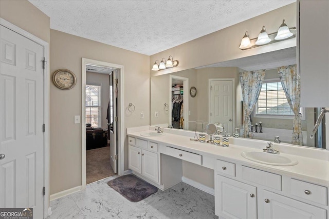 bathroom featuring vanity and a textured ceiling