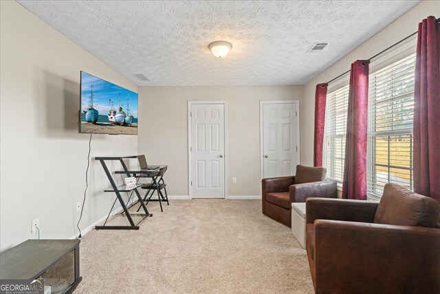 carpeted bedroom featuring a textured ceiling and ceiling fan