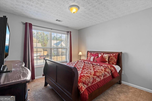 bedroom with carpet and a textured ceiling