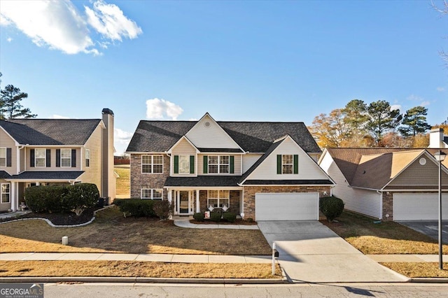 view of property with a garage and a front lawn