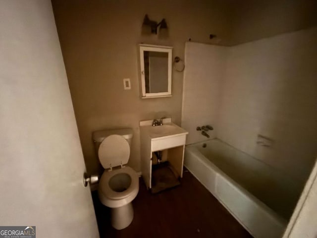 bathroom featuring toilet and a bath