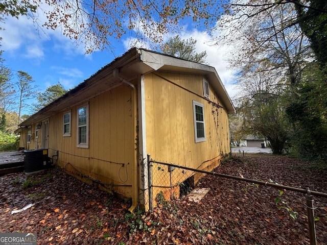 view of side of home with central AC unit