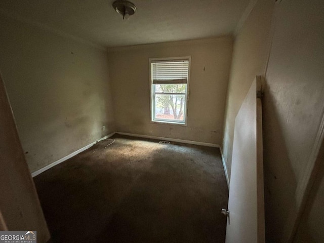 unfurnished room featuring carpet floors and ornamental molding