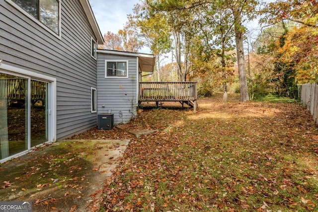 view of yard with central AC unit and a deck