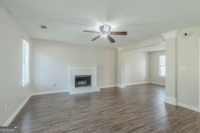 unfurnished living room featuring a textured ceiling, ceiling fan, and dark hardwood / wood-style floors