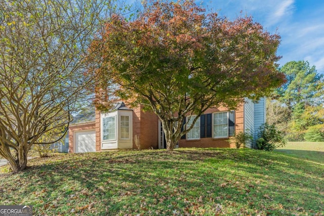 view of front of home with a garage and a front lawn