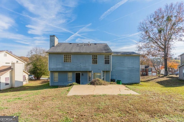 back of house with a yard and a patio area