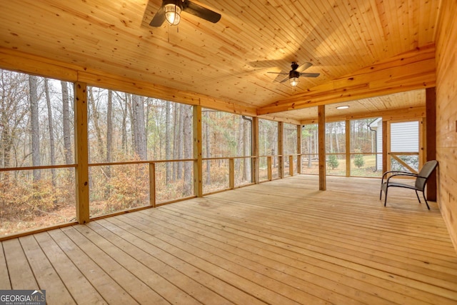 unfurnished sunroom featuring plenty of natural light, ceiling fan, and wood ceiling