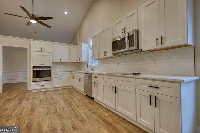 kitchen featuring ceiling fan, light hardwood / wood-style flooring, white cabinets, and stainless steel appliances