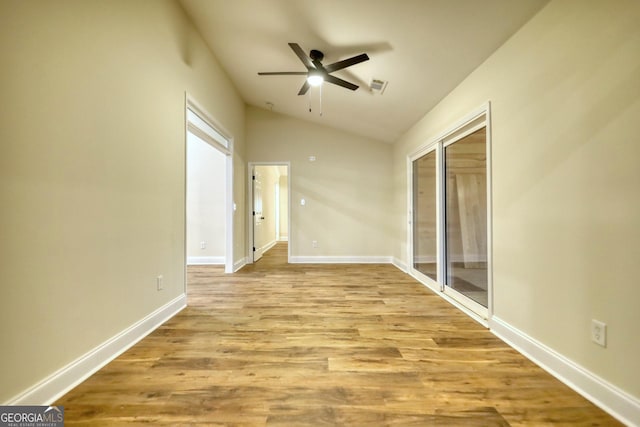 unfurnished room featuring ceiling fan, lofted ceiling, and light hardwood / wood-style flooring