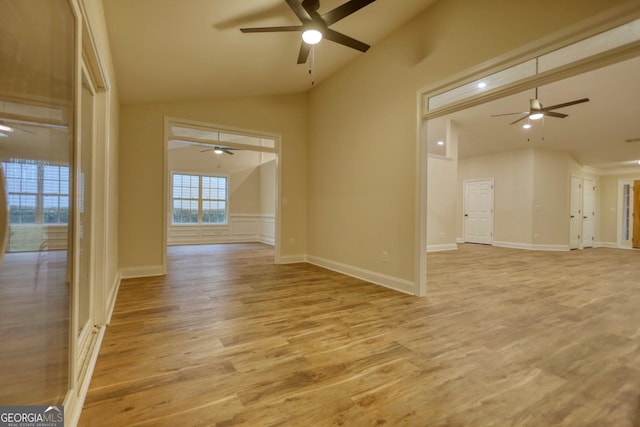 empty room with light hardwood / wood-style floors and lofted ceiling