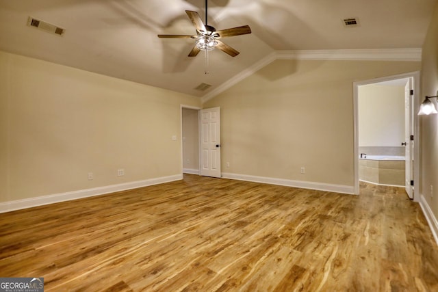 interior space featuring ceiling fan, light wood-type flooring, lofted ceiling, and ornamental molding