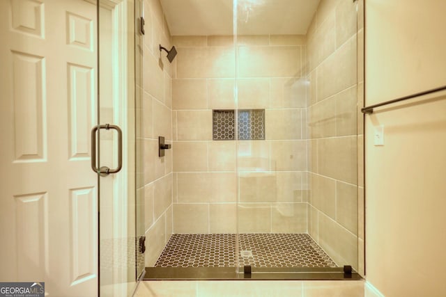 bathroom featuring a shower with shower door