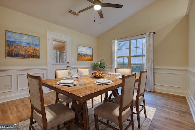 dining area featuring hardwood / wood-style flooring, ceiling fan, and lofted ceiling