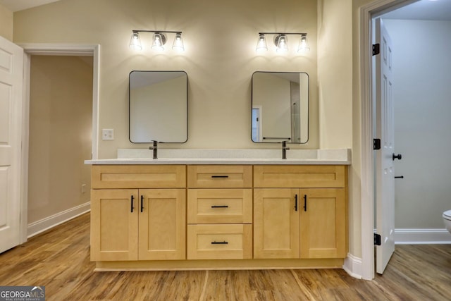 bathroom featuring hardwood / wood-style floors, vanity, toilet, and vaulted ceiling