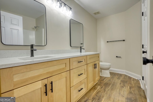 bathroom with vanity, hardwood / wood-style flooring, and toilet