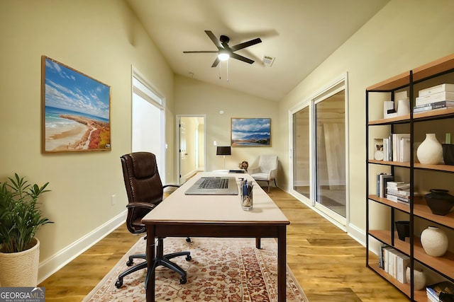 office space featuring light hardwood / wood-style floors, vaulted ceiling, and ceiling fan