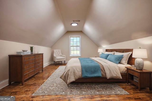 bedroom featuring dark hardwood / wood-style flooring and vaulted ceiling