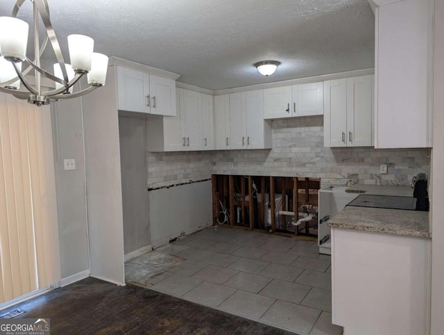 kitchen with white cabinets, decorative light fixtures, decorative backsplash, and a chandelier